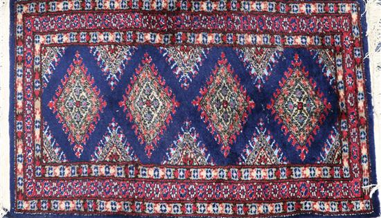 A small blue and red ground rug 100x 60cm